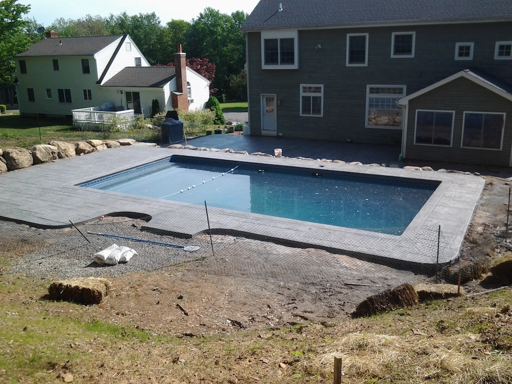 Pool project with finished deck and water features